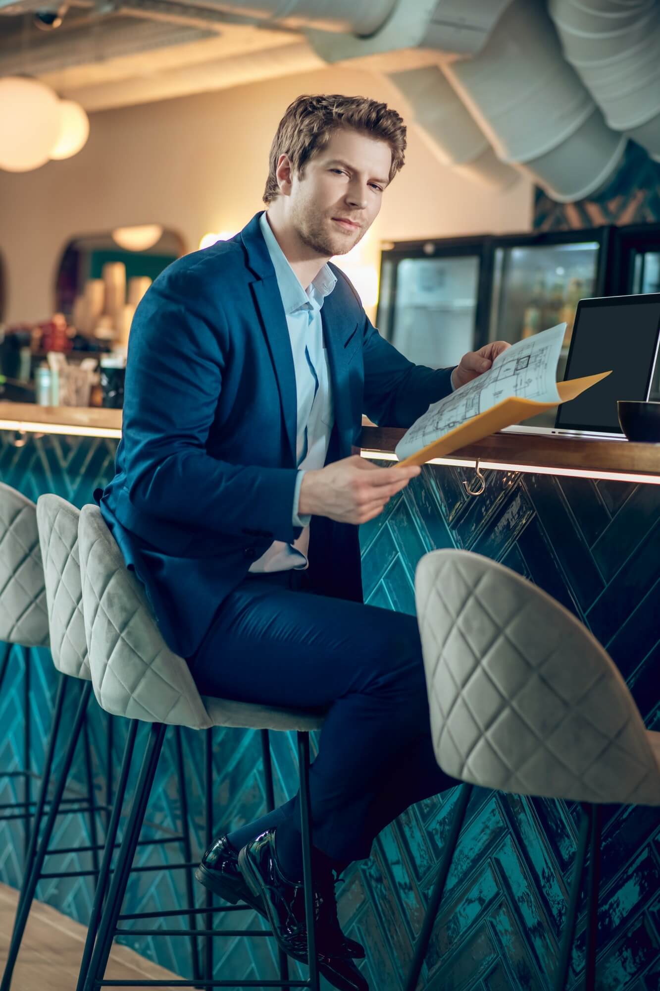 man-in-business-suit-with-document-in-cafe.jpg